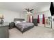 Comfortable bedroom with a ceiling fan, neutral color palette and natural light at 8411 Washoe Pine Ln, Charlotte, NC 28215