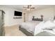 Neutral bedroom with a ceiling fan, television and decorative details create a tranquil setting at 8411 Washoe Pine Ln, Charlotte, NC 28215