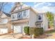 Charming two-story home with a well-maintained lawn and attached garage. It features light siding and crisp white trim at 8411 Washoe Pine Ln, Charlotte, NC 28215