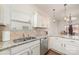 Bright kitchen with granite counters, stainless steel dishwasher, and tiled backsplash with a double sink at 8411 Washoe Pine Ln, Charlotte, NC 28215