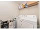 Laundry room with washer, dryer, and shelving for storage at 8411 Washoe Pine Ln, Charlotte, NC 28215