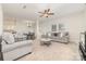 Bright and airy living room with neutral carpeting, a ceiling fan, and comfortable seating arrangements at 8411 Washoe Pine Ln, Charlotte, NC 28215