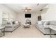 Spacious living room with plush sofas, a ceiling fan, and a mounted television for entertainment at 8411 Washoe Pine Ln, Charlotte, NC 28215