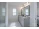 Bathroom offers double vanity, a large mirror, and bright, natural light at 9015 Ramsford Ct, Mint Hill, NC 28227