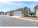 Row of garages with white doors and neutral siding, providing ample parking and storage space at 9015 Ramsford Ct, Mint Hill, NC 28227