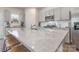 Close up of white granite kitchen island with stainless steel sink at 9015 Ramsford Ct, Mint Hill, NC 28227