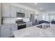 Modern eat-in kitchen featuring stainless steel appliances and white granite countertops at 9015 Ramsford Ct, Mint Hill, NC 28227