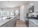 Modern kitchen featuring stainless steel appliances and white granite countertops at 9015 Ramsford Ct, Mint Hill, NC 28227