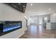 Open-concept living room with wood floors, electric fireplace, and natural light at 9015 Ramsford Ct, Mint Hill, NC 28227