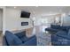 Cozy living room with a modern fireplace and view into kitchen area at 9015 Ramsford Ct, Mint Hill, NC 28227