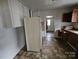 Kitchen with white refrigerator and brown cabinets at 905 Saluda St, Rock Hill, SC 29730