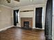 Living room with brick fireplace and hardwood floors at 905 Saluda St, Rock Hill, SC 29730