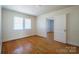 Bright bedroom with a large window, light walls and hardwood flooring at 105 W 21St St, Kannapolis, NC 28081