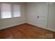 Bedroom features hardwood floors, two windows with blinds, and a white door at 105 W 21St St, Kannapolis, NC 28081