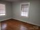 Bedroom with hardwood floors features two windows with blinds at 105 W 21St St, Kannapolis, NC 28081