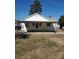 Rear view of a white house with carport and yard at 105 W 21St St, Kannapolis, NC 28081