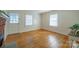 Well-lit living room features hardwood floors, brick fireplace with mantel, and multiple windows for natural light at 105 W 21St St, Kannapolis, NC 28081