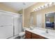 Bathroom featuring a shower, a vanity sink, and a well-lit mirror at 10628 Hill Point Ct, Charlotte, NC 28262