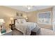 Comfortable bedroom featuring a floral bedspread, stylish lamps, and a window with patterned blinds at 10628 Hill Point Ct, Charlotte, NC 28262