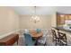 Dining area featuring a wooden round table with chandelier lighting and a cozy, carpeted floor at 10628 Hill Point Ct, Charlotte, NC 28262