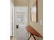 Inviting hallway with a decorative table and mirror, offering a glimpse into the brightly lit bedroom at 10628 Hill Point Ct, Charlotte, NC 28262