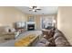 Relaxing living room with a fireplace and access to a balcony with wooded views at 10628 Hill Point Ct, Charlotte, NC 28262