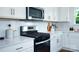 Stainless steel gas cooktop and white shaker cabinets in this kitchen at 10630 Tuff Ln, Davidson, NC 28036