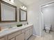 Bathroom with double sink vanity, framed mirrors, and tile floor at 11143 Coachman Cir, Charlotte, NC 28277