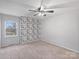 Bedroom with a leaf accent wall, ceiling fan, and carpeted floor at 11143 Coachman Cir, Charlotte, NC 28277