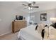 Well-lit bedroom with a dresser and tv, ceiling fan, and neutral decor at 11143 Coachman Cir, Charlotte, NC 28277