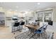 Open kitchen and dining space featuring a central island, modern appliances, and a stylish dining table at 11143 Coachman Cir, Charlotte, NC 28277