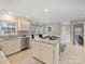 Spacious kitchen featuring a center island, modern appliances, and an adjacent dining area with a bay window at 11143 Coachman Cir, Charlotte, NC 28277