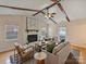 Inviting living room with vaulted ceiling, wood beams, fireplace, and ample natural light at 11143 Coachman Cir, Charlotte, NC 28277