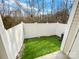 Private backyard with artificial turf and a white vinyl fence at 118 Cadbury Ln, Fort Mill, SC 29715