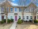 Tan siding townhouse with a pink door, landscaping, and walkway at 118 Cadbury Ln, Fort Mill, SC 29715