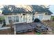 Birds-eye view of the backyard highlighting the deck, grill, stone firepit, and siding at 12016 Regent Ridge Ln, Charlotte, NC 28278