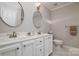 Modern bathroom with double sinks, ample storage, and decorative mirrors at 12016 Regent Ridge Ln, Charlotte, NC 28278