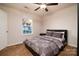 Bedroom features neutral walls, carpet, fan and ample natural light from the window at 12016 Regent Ridge Ln, Charlotte, NC 28278