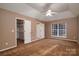 Spacious bedroom features neutral walls, carpet, fan and ample natural light from the large window at 12016 Regent Ridge Ln, Charlotte, NC 28278