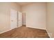 Neutral bedroom featuring plush carpet, double closet, and cream walls at 12016 Regent Ridge Ln, Charlotte, NC 28278