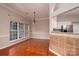 Dining room area with wood floors, natural light, and access to the kitchen at 12016 Regent Ridge Ln, Charlotte, NC 28278