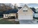 A cozy home featuring neutral siding, an attached two-car garage, and mature landscaping at 12016 Regent Ridge Ln, Charlotte, NC 28278