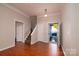 Inviting foyer with wood floors, stairs, and a view of the front yard through the open front door at 12016 Regent Ridge Ln, Charlotte, NC 28278