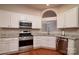 Well-lit kitchen featuring stainless steel appliances, countertops, and generous cabinet space at 12016 Regent Ridge Ln, Charlotte, NC 28278