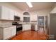 Modern kitchen featuring stainless steel appliances, granite countertops, and ample cabinet space at 12016 Regent Ridge Ln, Charlotte, NC 28278