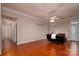 Open living room featuring hardwood floors, a ceiling fan, and ample natural light at 12016 Regent Ridge Ln, Charlotte, NC 28278