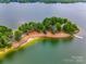 Aerial view of a peninsula with a walking trail, sandy beach, trees, and lake access at 12104 Baywoods Dr, Tega Cay, SC 29708