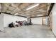 Large unfinished basement featuring concrete flooring, white walls, and multiple doors at 12104 Baywoods Dr, Tega Cay, SC 29708