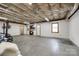 Spacious unfinished basement with concrete floor, white walls, and natural light from a window at 12104 Baywoods Dr, Tega Cay, SC 29708