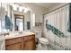 Bathroom featuring a peacock shower curtain, cabinet and granite countertop vanity at 12104 Baywoods Dr, Tega Cay, SC 29708